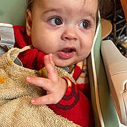 Zaïen participe au concours pour gagner de l'argent avec cette photo : baby, bib, child, closeup, curious, cute, expression, face, feeding_time, food_stains, furniture, hand, high_chair, indoor, infant, person, portrait, red_clothing, seat, young_child