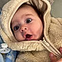 baby, blanket, child, clothing, cozy, cute, expression, face, fluffy, hand, hoodie, indoor, infant, pacifier, person, portrait, soft, warm, wide_eyes, zipper