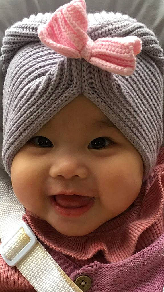 Faith is registered to the contest to win money with this photo: baby, cap, cheek, chin, clothing, eye, face, facial_expression, head, headwear, human, lip, nose, organ, outerwear, person, photograph, product, skin, smile