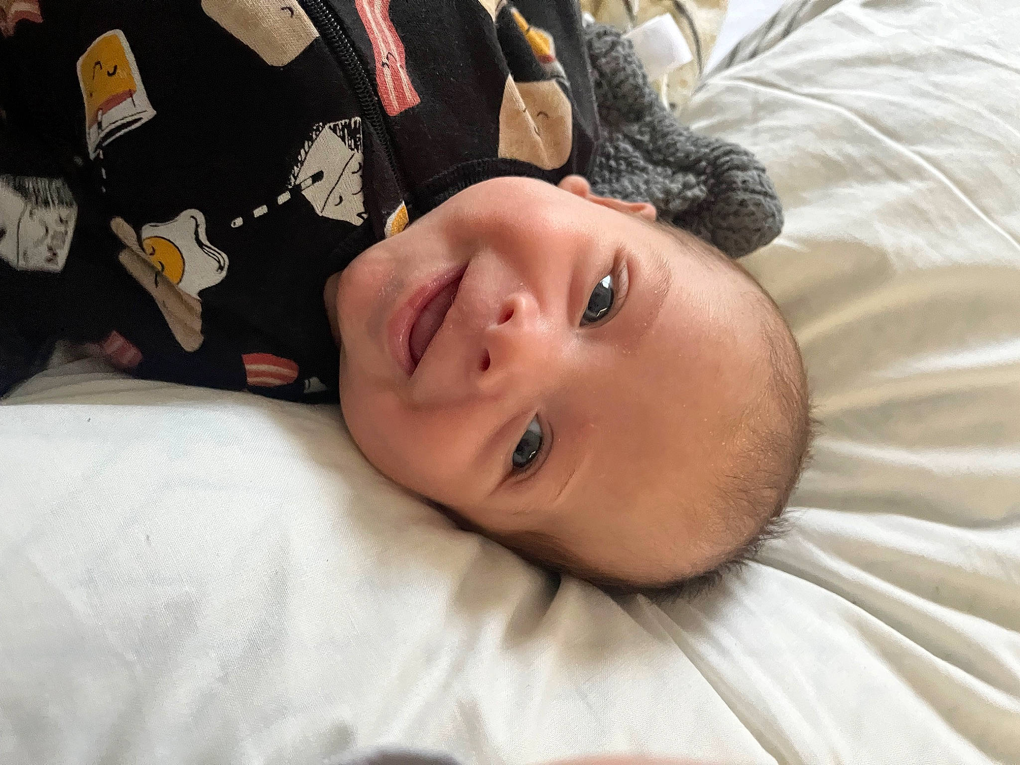 Lucas is registered to the contest to win money with this photo: bedding, black_hair, cheek, child, comfort, eyebrow, eyelash, fun, fur, happy, joy, linens, lip, neck, nose, person, portrait_photography, room, sleeve, smile