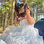 Ysabell joined the competition — help win amazing prizes! accessory, baby, child, cute, dress, fashion, forest, headwear, nature, outdoor, person, portrait, smile, summer, sunglasses, sunlight, toddler, trees, white_dress, young_child