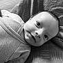 baby, black_and_white, blanket, child, closeup, clothing, cute, expression, eyes, face, head, infant, lying_down, monochrome, pattern, portrait, smile, soft, striped, young
