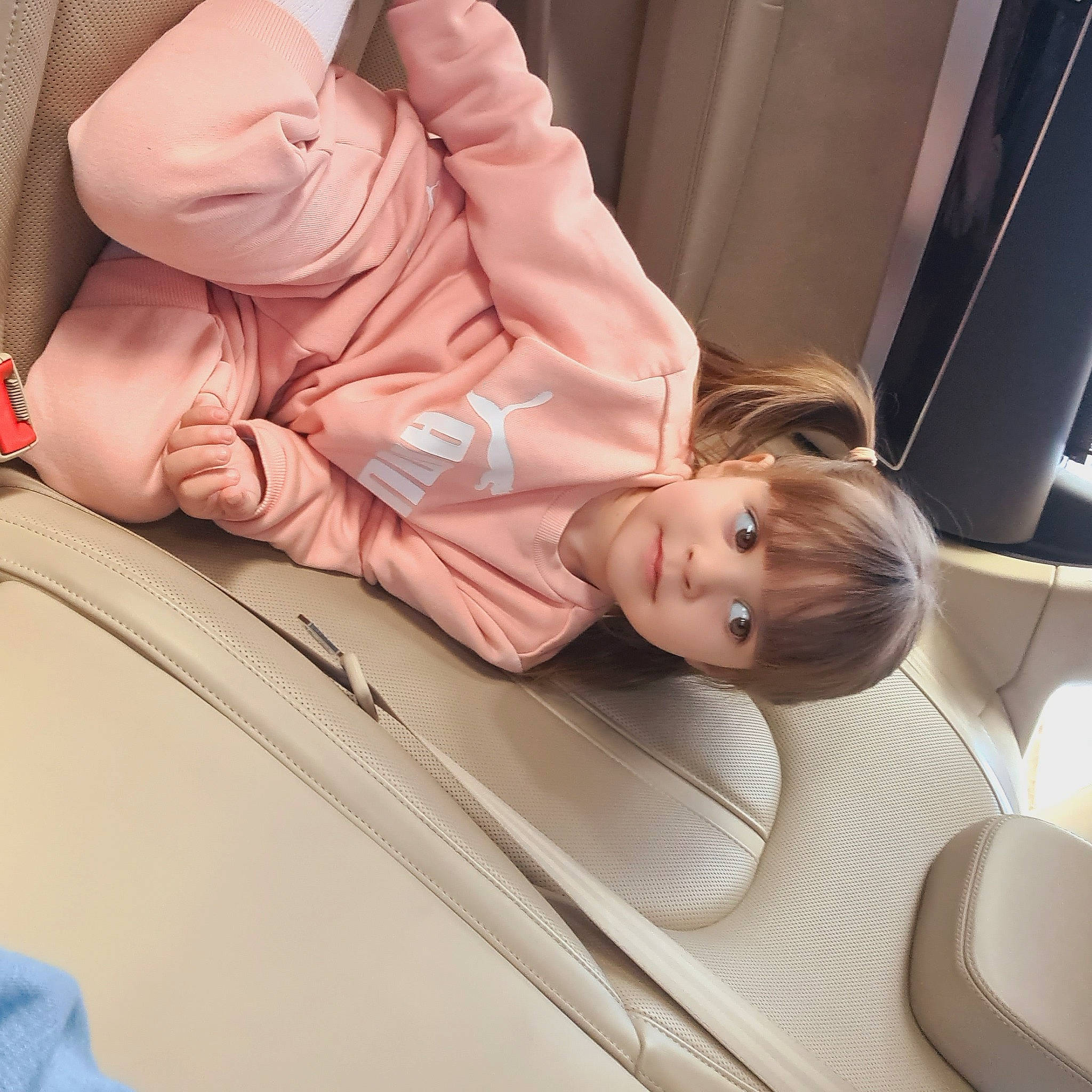 Adriana is registered to the contest to win money with this photo: automotive_design, automotive_exterior, blond, car, car_seat, child, comfort, doll, family_car, human_leg, linens, motor_vehicle, muscle, peach, person, personal_luxury_car, sitting, skin, toy, vehicle