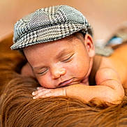 Raam is registered to the contest to win money with this photo: baby, sleeping, cap, houndstooth, fur, brown, soft, portrait, closeup, peaceful, child, resting, face, headwear, infant, cozy, warm, skin, cute, relax