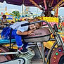 Alexa joined the competition — help win amazing prizes! amusement_ride, blue_pants, carnival, casual_clothing, child, colorful_lights, daytime, entertainment, fairground, fun, handlebars, motorcycle_ride, outdoor, people, playful, seat, smiling, toddler, white_shirt, young_child