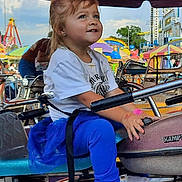 Alexa joined the competition — help win amazing prizes! amusement_park, blue_pants, child, colorful, daytime, entertainment, family, fun, girl, handlebar, happy, leisure, outdoor, playful, pony_tail, ride, seat, smile, white_shirt, young