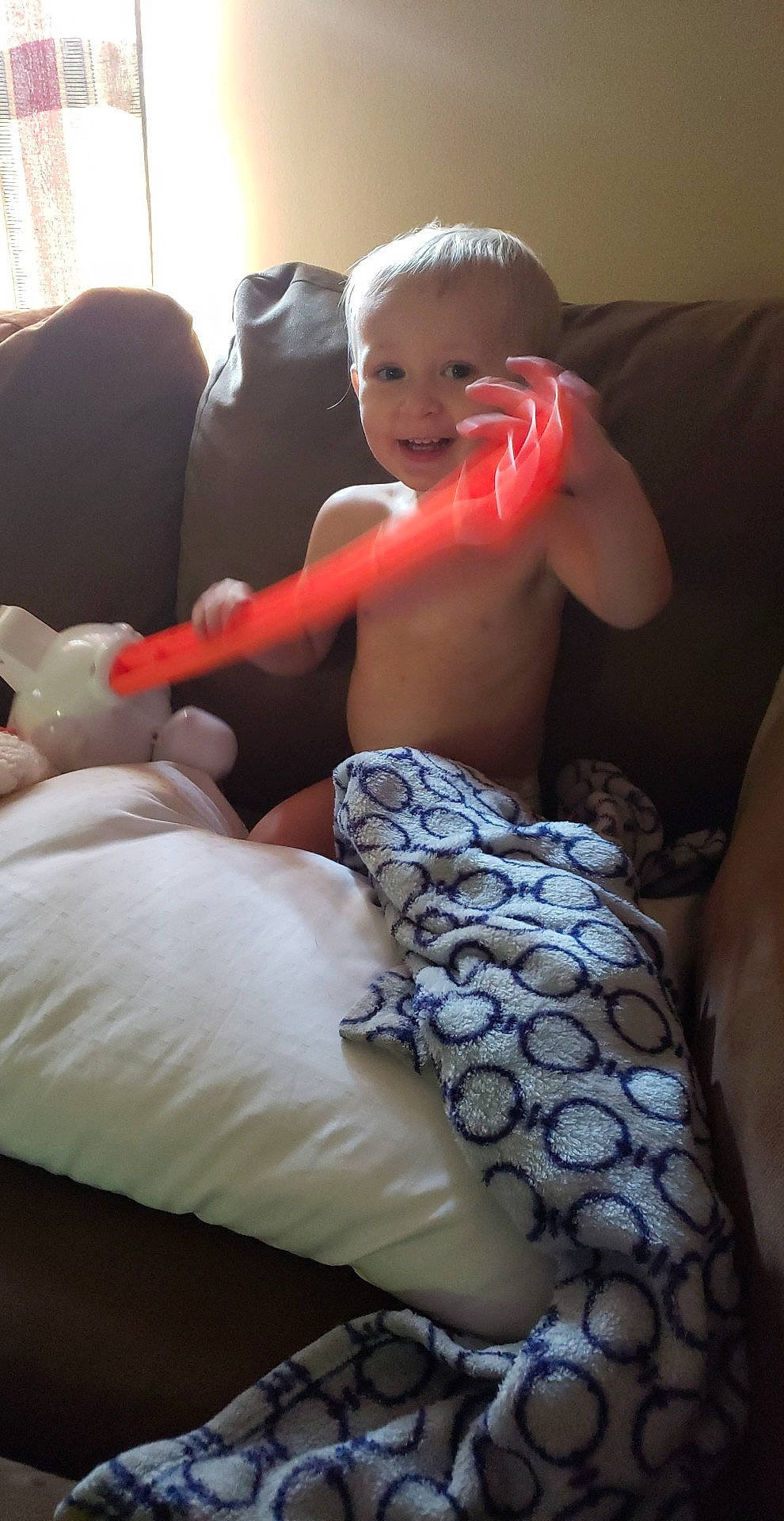 Aiden is registered to the contest to win money with this photo: abdomen, arm, baby, birth, child, electronic_device, finger, furniture, leg, linens, muscle, person, skin, toddler, vacation