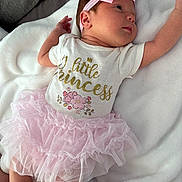 Emersyn joined the competition — help win amazing prizes! baby, newborn, infant, girl, portrait, lying_down, pink_bow, headband, tutu, dress, onesie, blanket, white_blanket, sleeping_area, face, eyes, smiling, indoors, fashion, cute