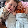 Emersyn is registered to the contest to win money with this photo: child, baby, sibling, infant, sleeping, smiling, portrait, bed, blanket, bedding, home, indoor, cuddling, face, eyes, hair, clothing, orange_outfit, pink_pillow, toy