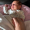 Emersyn is registered to the contest to win money with this photo: newborn, baby, infant, sleeping, face, portrait, indoors, blanket, pink_blanket, onesie, clothing, family, hand, adult_hand, couch, leather, sunlight, cozy, resting, close_up