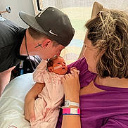Emersyn joined the competition — help win amazing prizes! adult, baby, bed, caregiving, child, closeup, cuddling, family, father, hospital, hospital_room, infant, mother, newborn, parents, pink_outfit, portrait, sleeping, window, wristband
