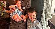 Emersyn is registered to the contest to win money with this photo: family, children, newborn, baby, toddler, parents, portrait, smiling, indoors, standing, holding, infant, boy, girl, adults, clothing, chair, painting, plant, home