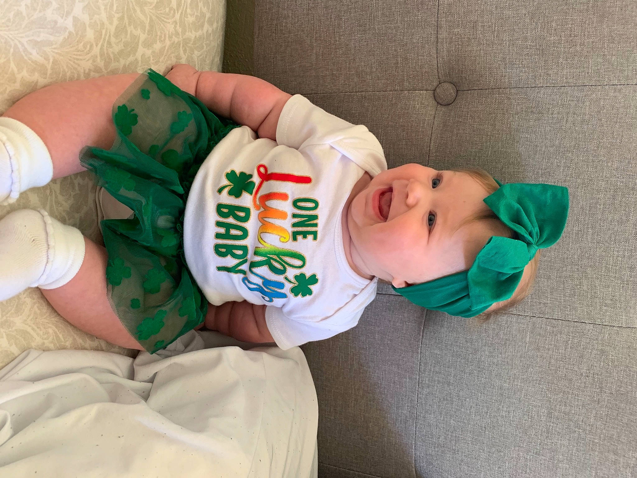 Lilah is registered to the contest to win money with this photo: baby, baby_toddler_clothing, child, comfort, elbow, foot, hat, headwear, human_leg, knee, linens, nail, person, product, room, sleeve, smile, sock, textile, thigh