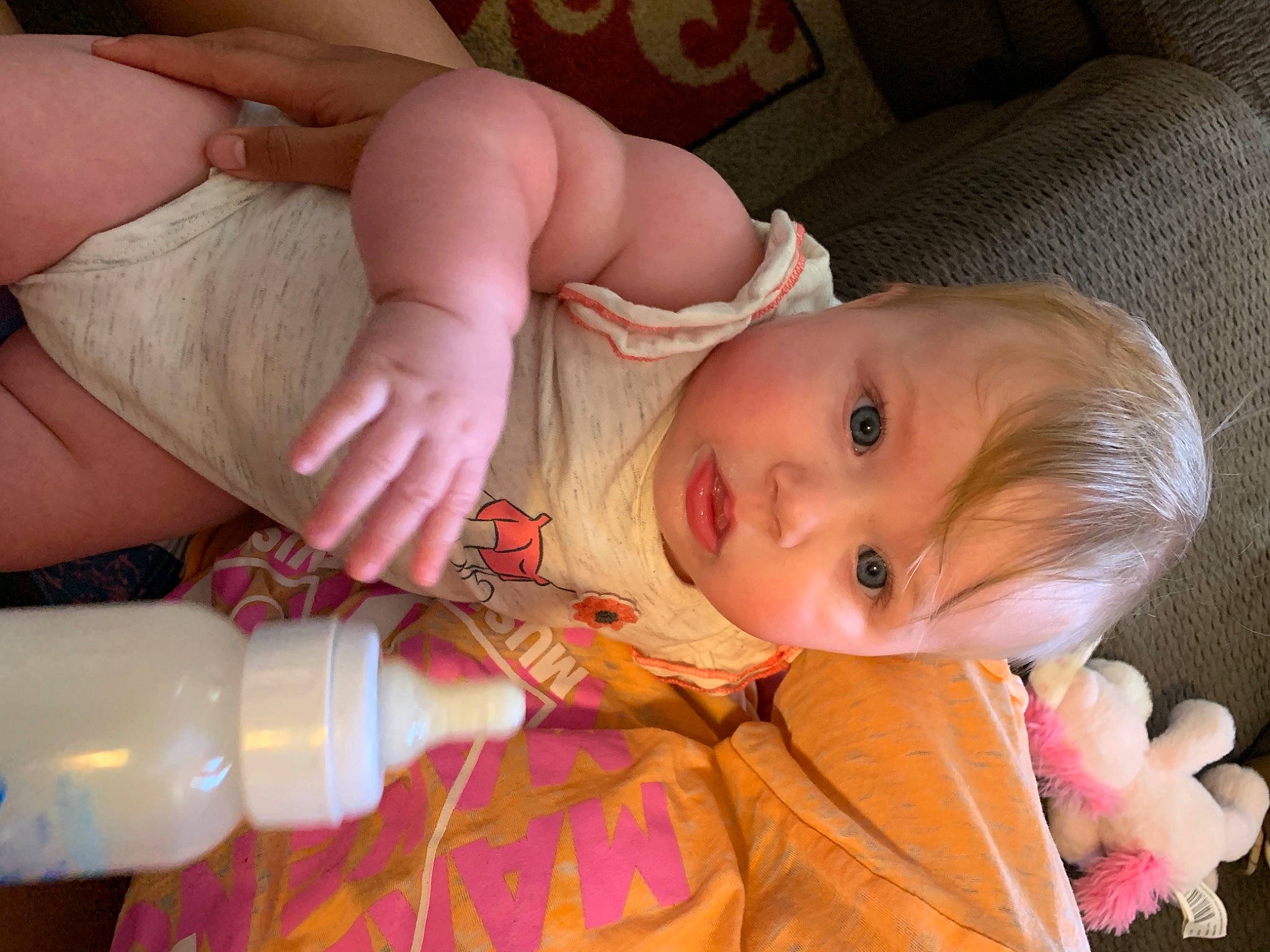 Lilah is registered to the contest to win money with this photo: arm, baby, baby_bottle, baby_toddler_clothing, bottle, cheek, comfort, eye, finger, head, human_body, iris, lip, mouth, nose, organ, person, pink, plastic_bottle, skin
