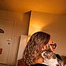 cat, person, human, pet, portrait, indoors, warm_lighting, glasses, shoulder, affection, cuddling, white_cat, tabby_cat, long_hair, seated, home, room, door, cozy, photography