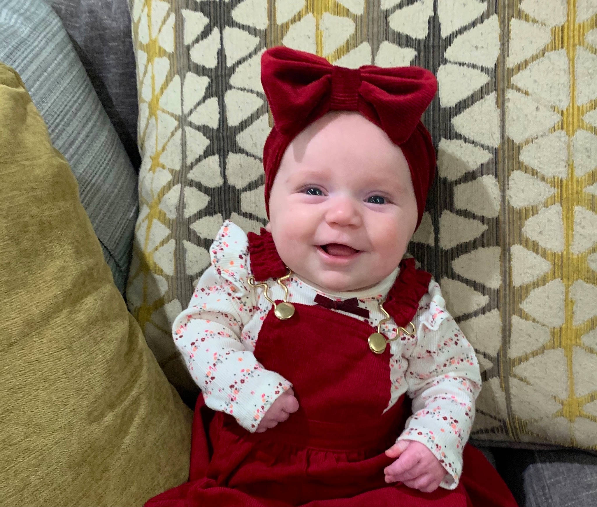 Marlie is registered to the contest to win money with this photo: baby, baby_laughing, baby_toddler_clothing, bonnet, child, costume, costume_accessory, costume_hat, eye, headwear, joy, linens, mesh, nose, pattern, person, pink, slipcover, textile, throw_pillow