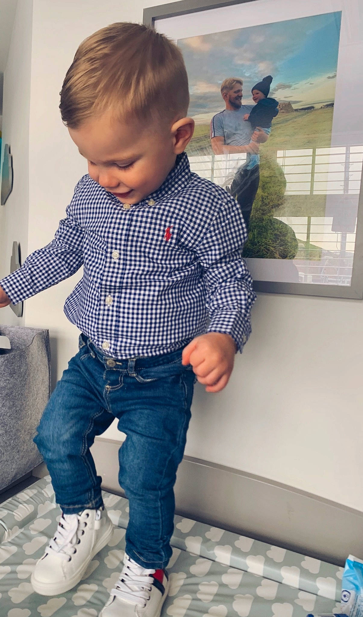 Benny is registered to the contest to win money with this photo: arm, blue, cheek, child, clothing, cool, denim, design, footwear, jeans, male, outerwear, person, play, product, shoe, shoulder, sleeve, standing, t_shirt