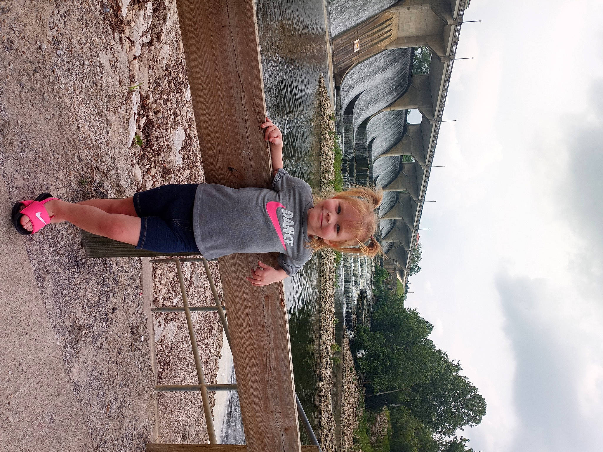 Kaitlyn is registered to the contest to win money with this photo: building, cloud, facade, fun, human_leg, joy, outdoor_shoe, person, plant, sky, smile, street_fashion, t_shirt, tree, waist, walking_shoe, wood