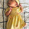 Amelia is registered to the contest to win money with this photo: baby, blanket, child, cozy, cute, geometric, headband, indoors, infant, newborn, pattern, peaceful, person, portrait, quilt, rest, sleeping, small_hands, soft, yellow_dress