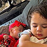 baby, casual, child, closeup, comfort, couch, cute, family, headband, indoor, minnie_mouse, peaceful, portrait, red_clothing, relaxation, rest, sleeping, soft_lighting, toddler, two_children