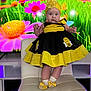 Valeria joined the competition — help win amazing prizes! baby, child, costume, bee_costume, yellow, black, dress, headband, flower, chair, socks, bow, indoor, portrait, cute, standing, infant, person, colorful, background