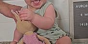 Aurora joined the competition — help win amazing prizes! baby, child, headband, bow, toy, stuffed_animal, bunny, pink_dress, smiling, tongue_out, sitting, hand, blanket, indoor, portrait, cute, happy, person, face, playful
