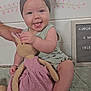 Aurora joined the competition — help win amazing prizes! baby, child, headband, bow, toy, stuffed_animal, bunny, pink_dress, smiling, tongue_out, sitting, hand, blanket, indoor, portrait, cute, happy, person, face, playful