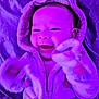 baby, child, smiling, hooded_clothing, mittens, purple_light, cozy, blanket, cute, infant, happy, portrait, soft_texture, indoor, warm, face, person, apparel, young, playful