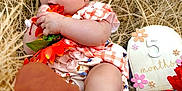 Leilani joined the competition — help win amazing prizes! baby, infant, headband, bow, flower, boots, straw, milestone, 5_months, cute, outdoor, nature, portrait, child, clothing, pink, orange, skin, sitting, decor