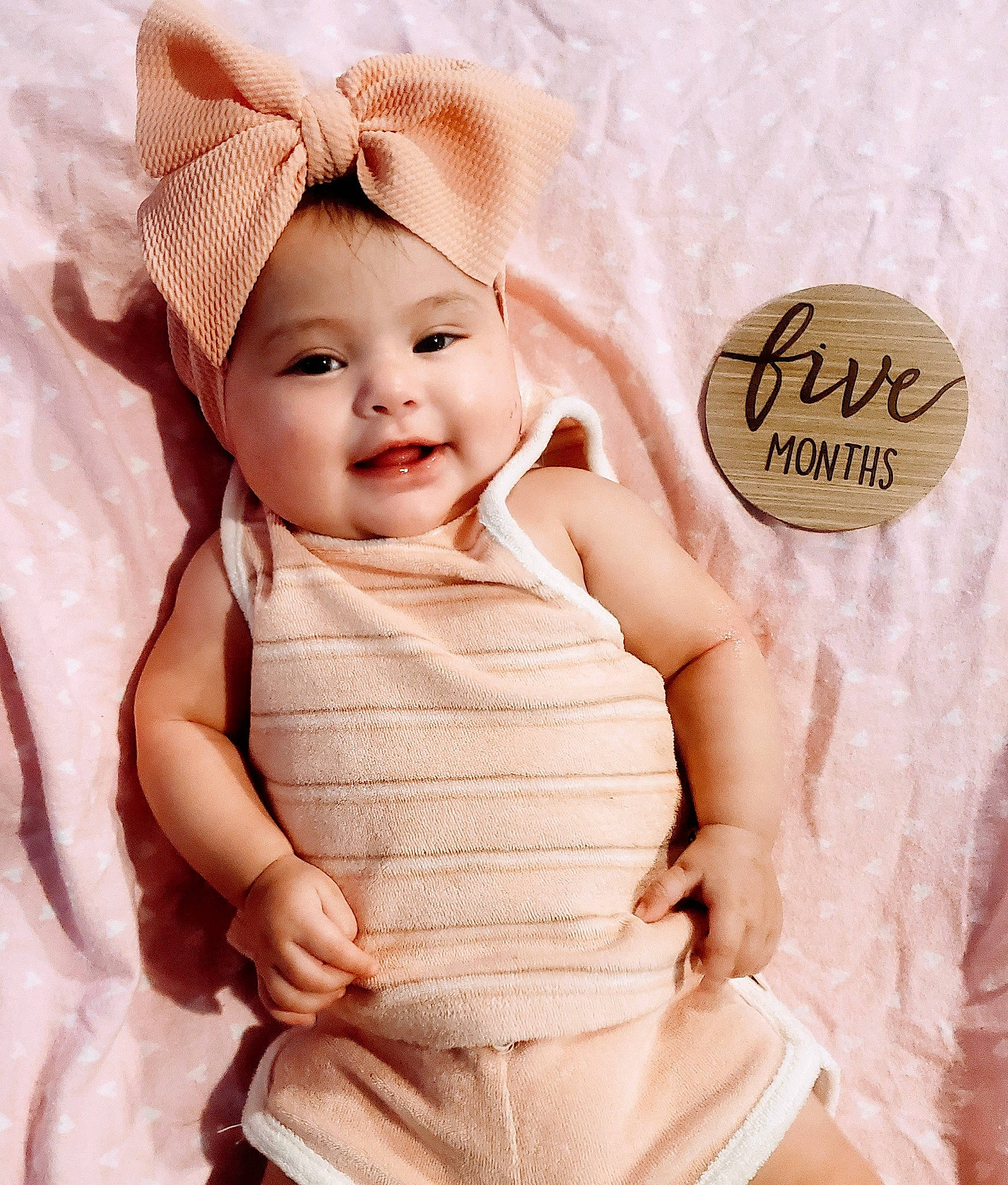 Kamila joined the competition — help win amazing prizes! baby, baby_toddler_clothing, child, comfort, face, fashion_accessory, finger, gesture, happy, linens, magenta, pattern, peach, person, pink, product, skin, sleeve, smile, thigh