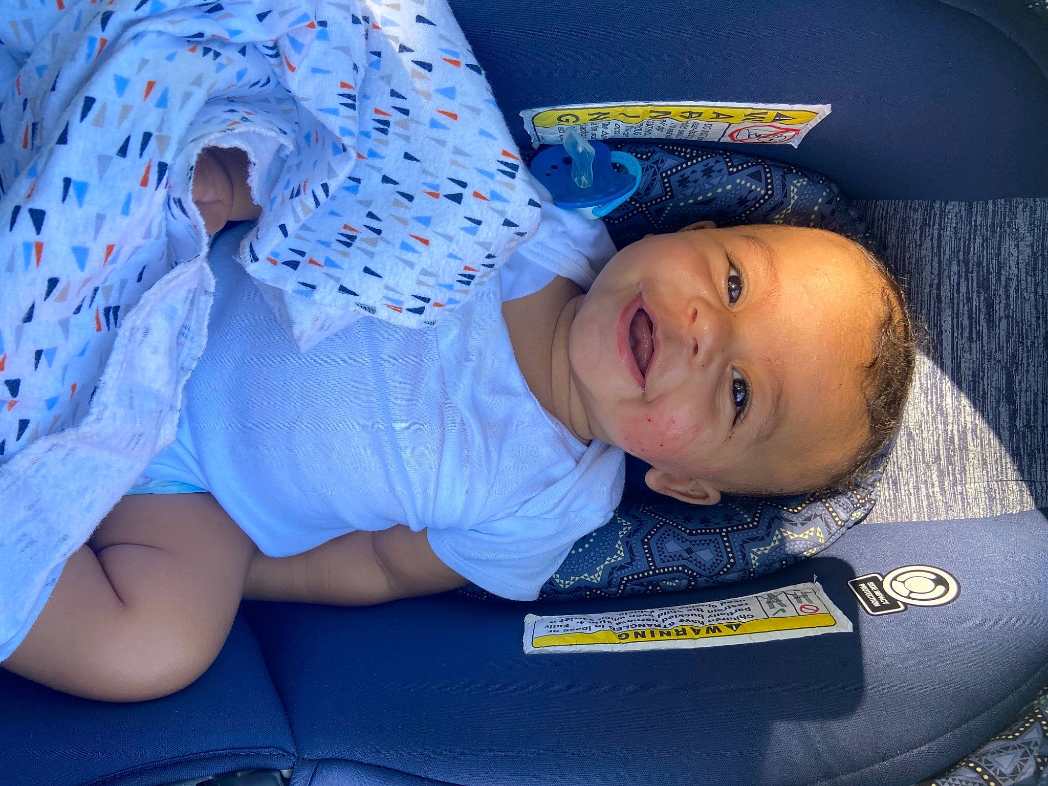 Jeremiah is registered to the contest to win money with this photo: arm, azure, baby, baby_safety, baby_toddler_clothing, blue, child, comfort, electric_blue, finger, fun, hand, happy, headgear, human_body, mouth, person, skin, sleeve, smile