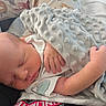 newborn, baby, sleeping, blanket, hand, soft_texture, cushion, animal_print, cozy, infant, cute, resting, peaceful, indoors, child, person, comfort, closeup, portrait, sleep