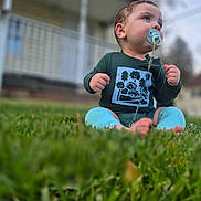Jacob Enmanuel joined the competition — help win amazing prizes! baby, baby_boy, casual_clothing, child, close_up, cute, daylight, expression, grass, green_clothing, infant, lawn, looking_away, nature, one_person, outdoor, pacifier, portrait, sitting, young_child