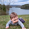 baby, child, grass, outdoor, lake, nature, sky, tree, water, toddler, curious, crawling, greenery, landscape, person, young_child, casual_clothing, daytime, relaxing, scenery