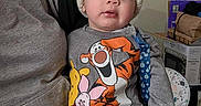 Jacob Enmanuel joined the competition — help win amazing prizes! adult, baby, child, clothing, cozy, curious, face, hat, home, indoor, knit_hat, lap, pants, person, piglet, pom_pom, seated, sweatshirt, tigger, winnie_the_pooh