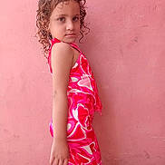 Rosa Nikol is registered to the contest to win money with this photo: casual, child, colorful, colorful_clothing, confident, curly_hair, fashion, full_body, girl, outdoor, patterned_outfit, person, pink_wall, portrait, posing, side_view, standing, vibrant, wall, young