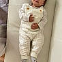 Noah participe au concours pour gagner de l'argent avec cette photo : baby, child, infant, white_clothing, knitted_overalls, socks, couch, leather, smiling, lying_down, indoor, cute, portrait, hands, feet, cozy, soft_lighting, home, comfortable, young_child