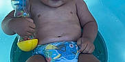Noah participe au concours pour gagner de l'argent avec cette photo : toddler, child, baby, pool, water, toy, rattle, diaper, blue, wet_hair, sitting, smiling, outdoor, playtime, summer, skin, legs, hand, fun, childhood