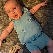 Carter joined the competition — help win amazing prizes! baby, infant, smile, knitted_clothing, blue_outfit, lying_down, milestone_sign, wooden_sign, two_months, happy, cute, arm, leg, face, infant_clothing, texture, fabric, cozy, portrait, child