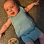 baby, infant, smile, knitted_clothing, blue_outfit, lying_down, milestone_sign, wooden_sign, two_months, happy, cute, arm, leg, face, infant_clothing, texture, fabric, cozy, portrait, child