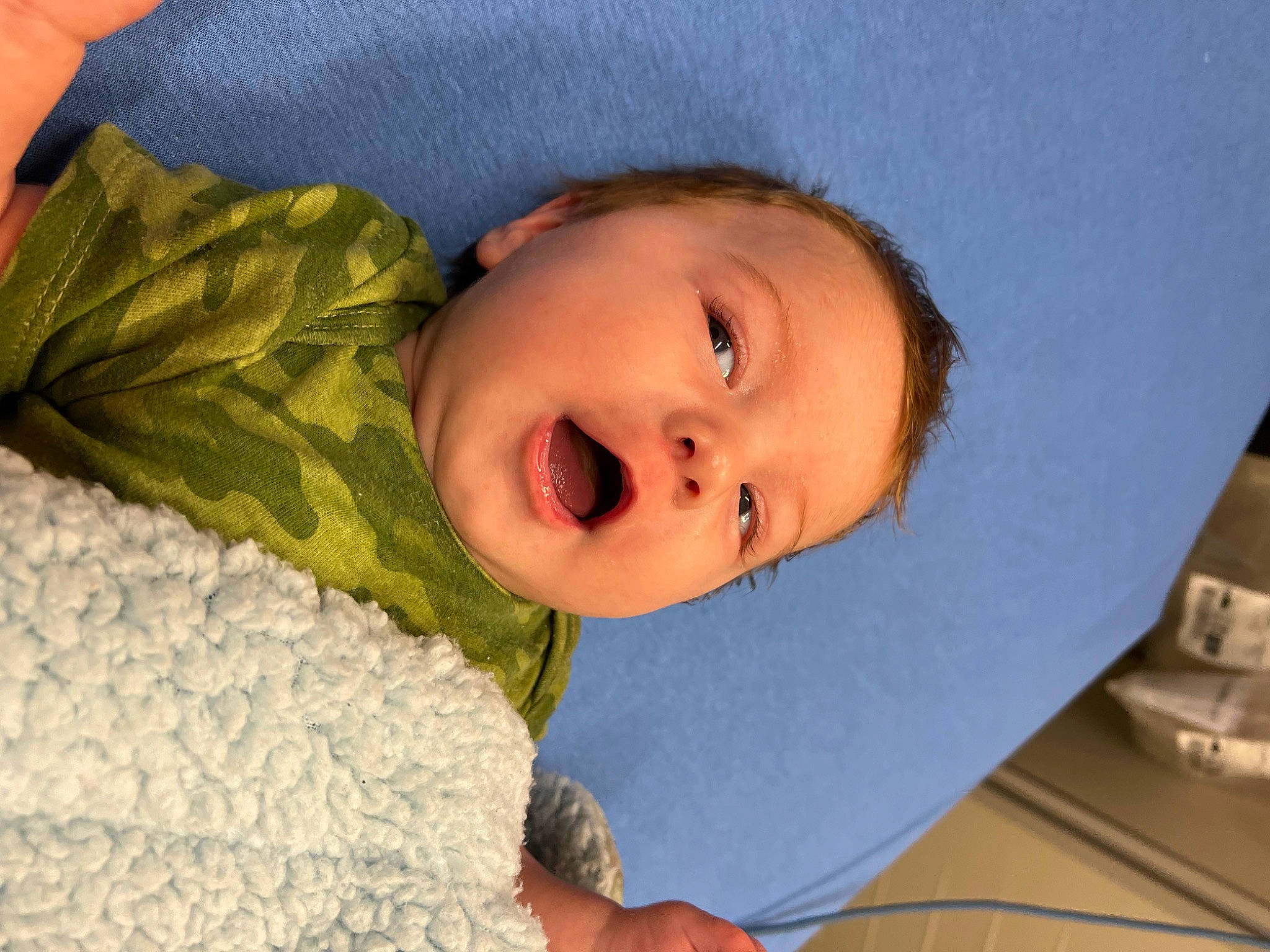 Jameson is registered to the contest to win money with this photo: baby, baby_toddler_clothing, cheek, child, comfort, electric_blue, eye, eyebrow, face, happy, iris, linens, lip, nose, pattern, person, room, skin, sleeve, smile
