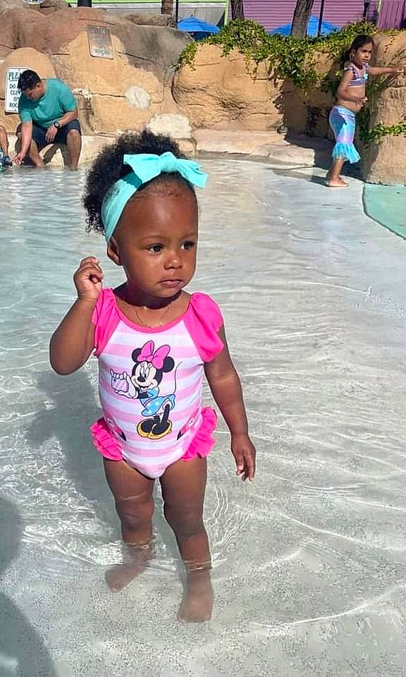 Kaitlynn is registered to the contest to win money with this photo: baby_toddler_clothing, blue, body_of_water, clothing, cool, face, facial_expression, green, happy, head, leisure, morning, person, pink, public_space, recreation, skin, summer, thigh, toddler