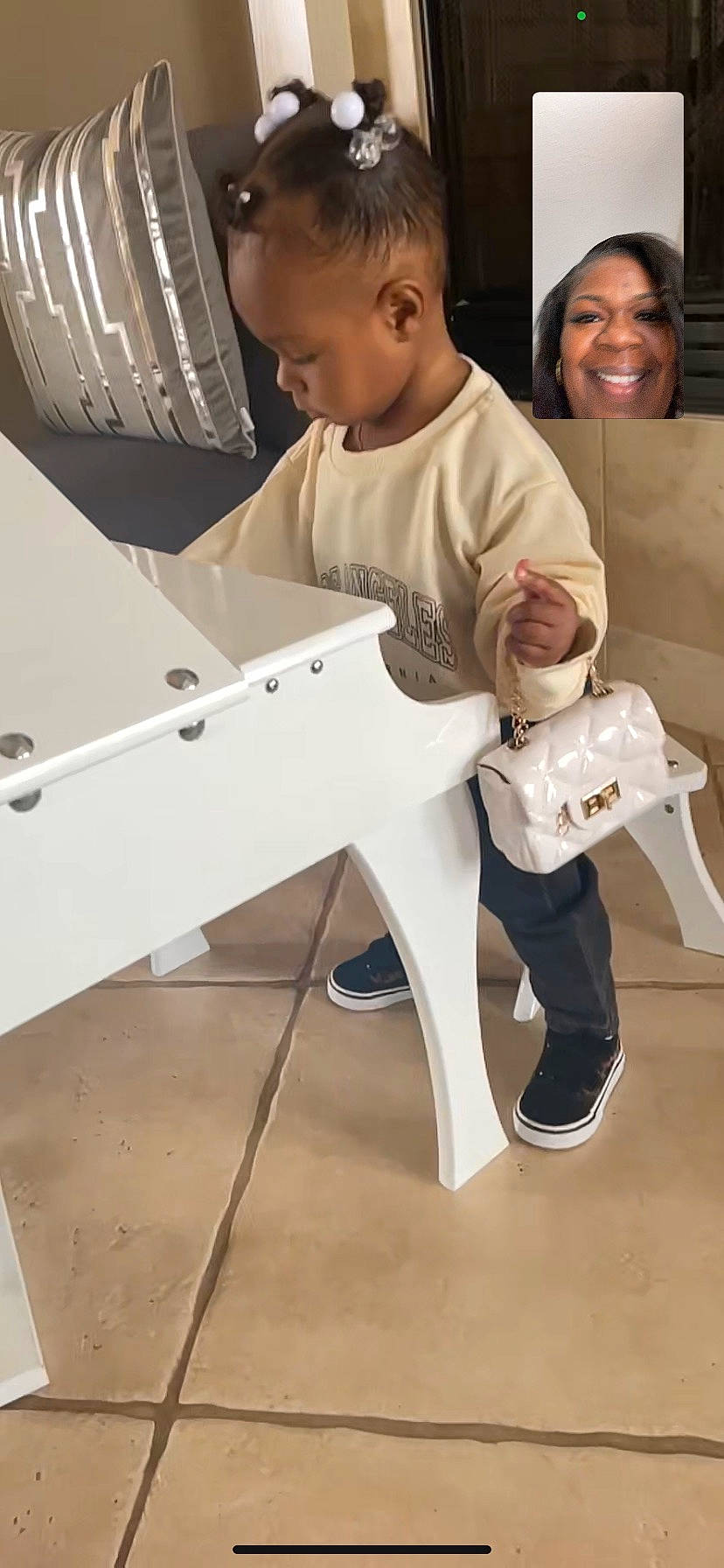 Kaitlynn is registered to the contest to win money with this photo: baby, flooring, hair, head, human_body, human_leg, joy, knee, leg, machine, person, shoe, shoulder, sitting, smile, standing, t_shirt, thigh, toddler, toy