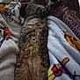 cat, tabby_cat, sleeping, blanket, patterned_blanket, fur, cozy, indoor, resting, animal, pet, soft, warm, relaxed, lying_down, feline, cute, home, comfort, nap