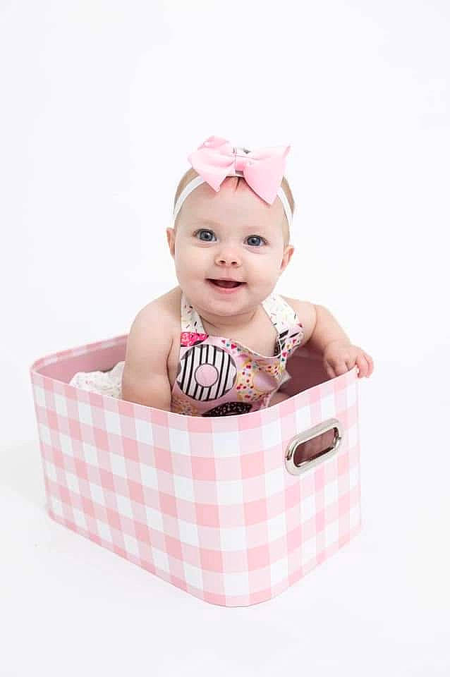 Kinsleigh is registered to the contest to win money with this photo: baby, baby_products, baby_toddler_clothing, basket, box, child, fashion_accessory, font, hair_accessory, happy, head, headwear, home_accessories, joy, magenta, pattern, person, pink, portrait_photography, rectangle