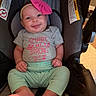 baby, infant, smile, headband, pink_bow, car_seat, clothing, onesie, happy, cute, portrait, child, sitting, feet, hands, indoor, person, apparel, seat, infant_clothing