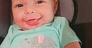 Josie is registered to the contest to win money with this photo: baby, smiling, infant, shirt, elephant, mint_green, clothing, car_seat, seat, child, cute, happy, face, portrait, arm, indoors, comfortable, young, baby_girl, baby_boy