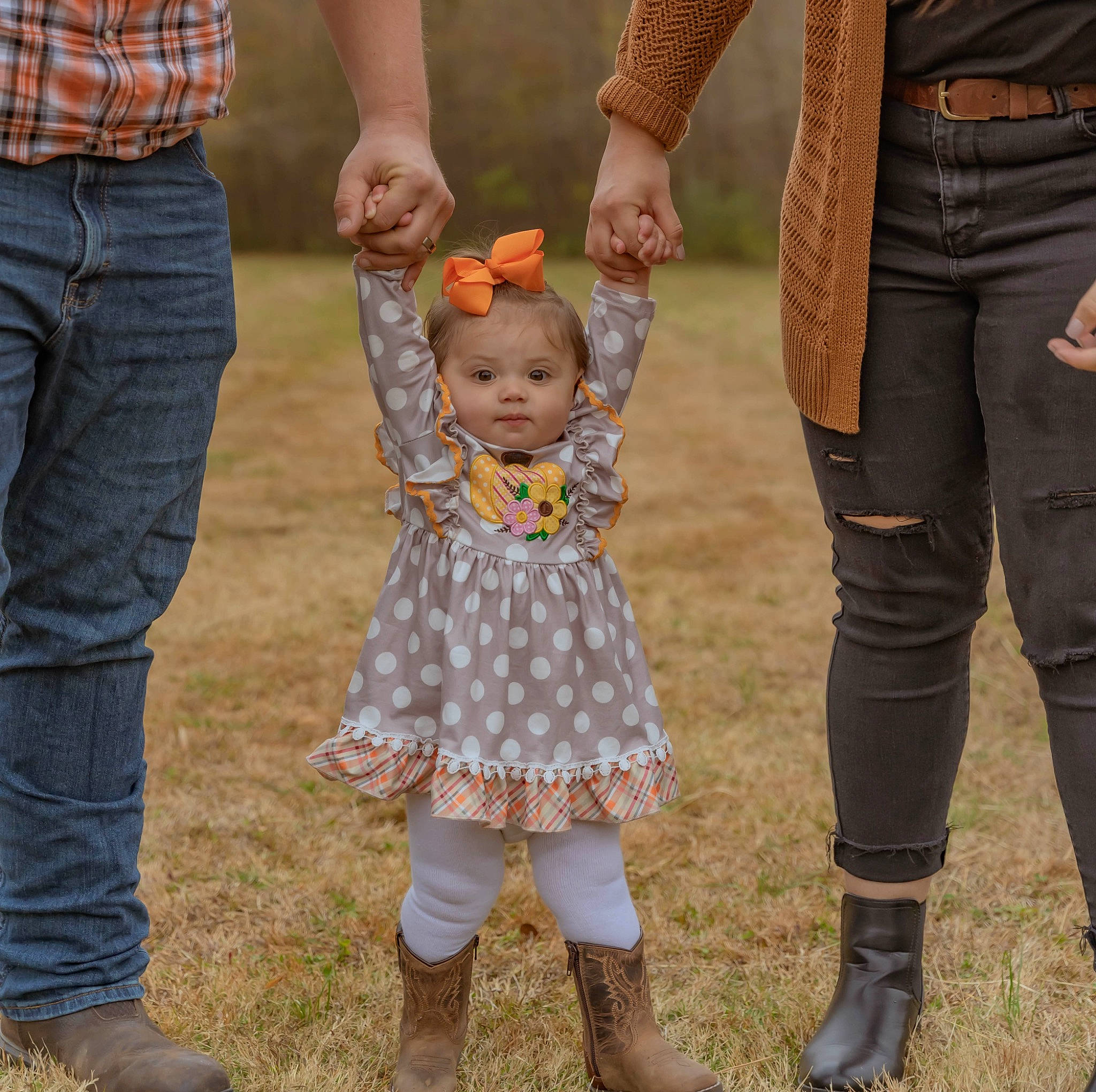 Ryleighann joined the competition — help win amazing prizes! baby, boot, child, clothing, event, footwear, fun, gesture, grass, hand, happy, holding_hands, human_leg, lawn, leg, pattern, people, people_in_nature, person, shoe