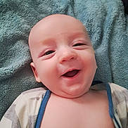 Mikey joined the competition — help win amazing prizes! baby, smile, happy, infant, face, blanket, clothing, striped, closeup, young, skin, cute, child, lying, portrait, expression, indoors, soft, warm, comfort