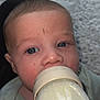 Oakley joined the competition — help win amazing prizes! baby, bottle, feeding, face, blue_eyes, infant, closeup, skin, mouth, hand, clothing, texture, scratches, young_child, person, cute, indoors, portrait, expression, nurturing